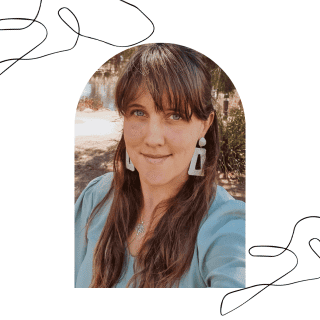 About Author - woman with long brown hair, white earrings, green shirt