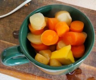 boiled carrots and parsnips in mug for baby food